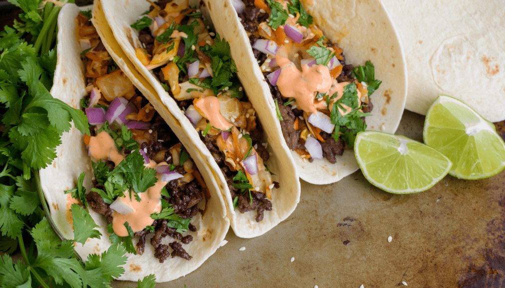 Korean tacos and garnishes on a surface